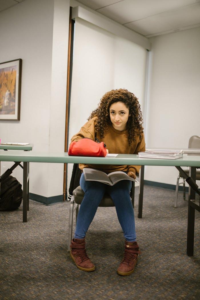 A dedicated college student studying at a desk, looking focused and determined to succeed.